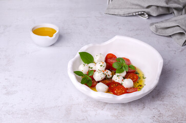 Tomato slices with cheese balls and spicy oil