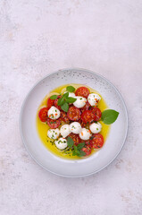 Tomato slices with cheese balls and spicy oil