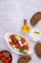 Tomato slices with cheese balls and spicy oil