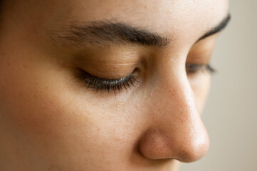 Fototapeta premium Close-up portrait of a young caucasian woman before eyelash lamination procedure. 