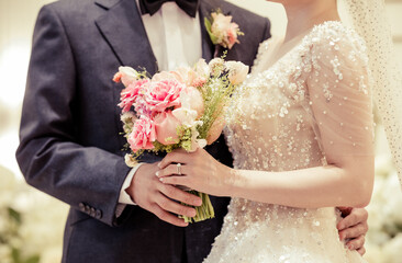 Bride and groom together, and holding the wedding bouquet