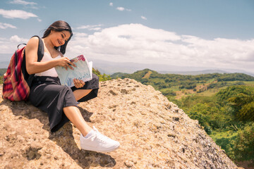 Nicaraguan teenager reading a textbook on top of a mountain in Jinotega Nicaragua