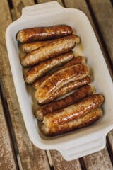 browned, cooked individual breakfast sausage links in white dish