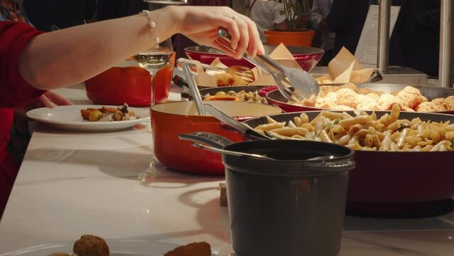 People get their food from a buffet with several hot and cold dishes of different foods  All-you-can-eat style
