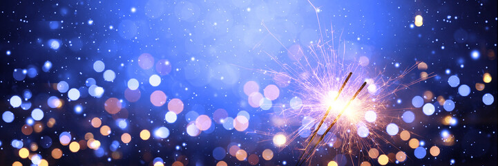 Fototapeta na wymiar Happy New Year background with glowing sparklers.