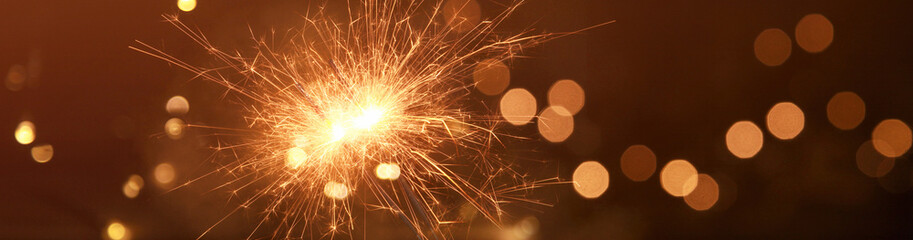 Happy New Year background with glowing sparklers.