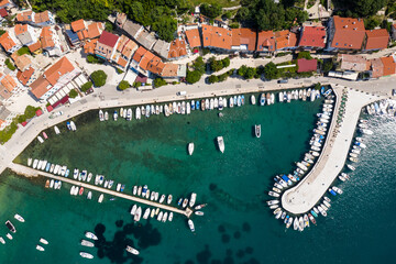 Aerial view of the Baska town and marina in the Krk island in Croatia in the Balkans by the Adriatic sea - obrazy, fototapety, plakaty