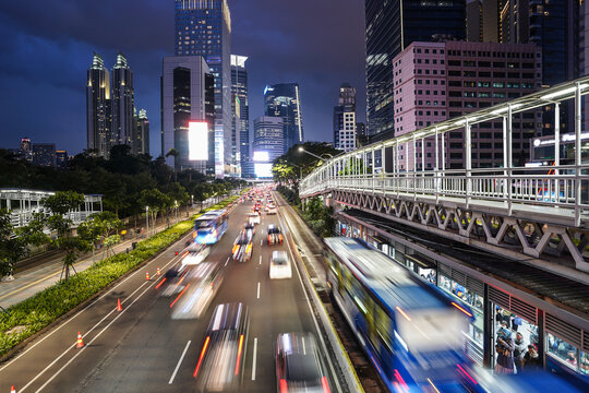 Jakarta, Indonesia: Traffic captured with blurred motion rushes on the Jakarta business district at dusk in the modern Indonesia capital city
