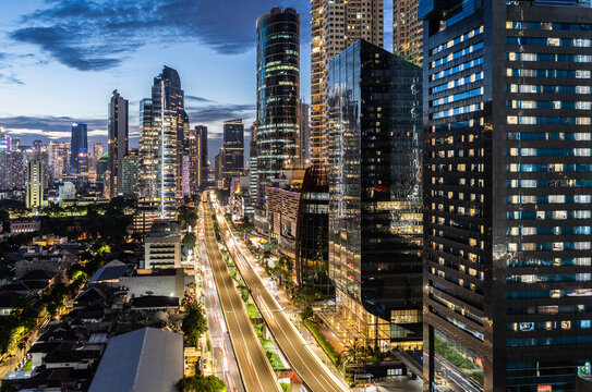 Fototapeta Dramatic aerial view of the Kuningan business district in Jakarta, the modern capital city of Indonesia in Southeast Asia at twilight.