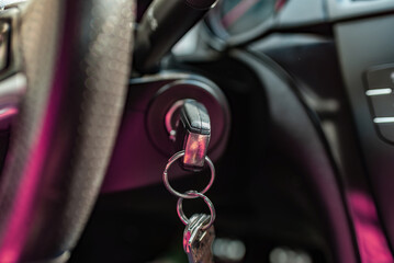 Key inserted into the lock of ignition of the car.Car ignition key.Car key in the ignition. Black...