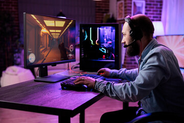 Male gamer focusing on online video games championship, playing action game on online live stream....