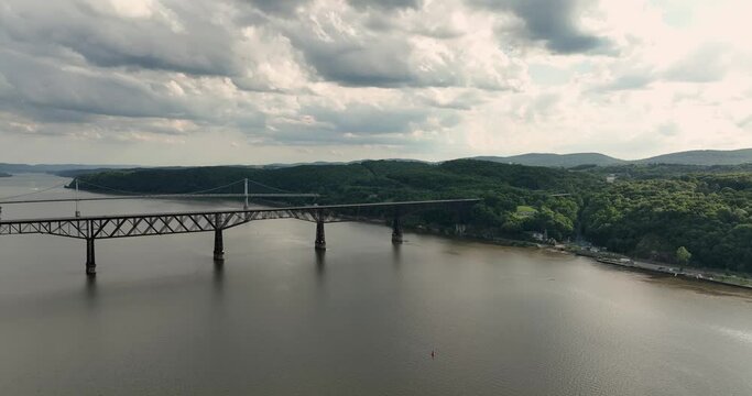 Summer afternoon aerial drone video of the Hudson River, Poughkeepsie, NY, walking bridge and Mid-Hudson Bridge of the Hudson River.. 