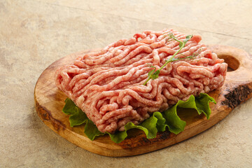 Raw minced pork meat over board