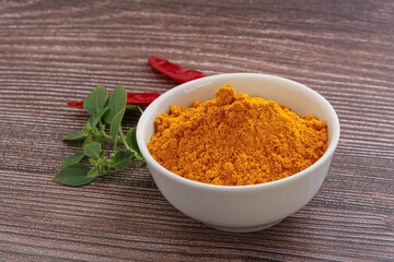 Yellow vibrant curcuma powder in the bowl