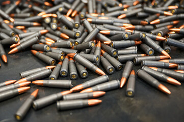 Scattered service cartridges on table at military plant - obrazy, fototapety, plakaty