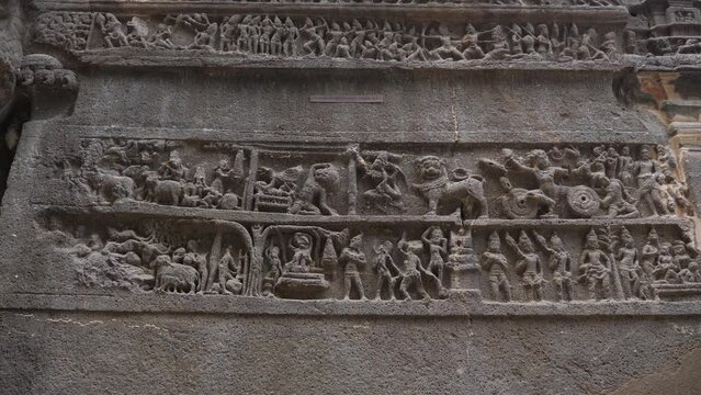Sculptures and symbols of different gods designed over wall of ellora caves