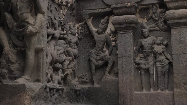 View of different gods sculptures made over ellora caves building walls