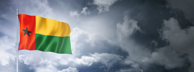 Guinea Bissau flag on a cloudy sky