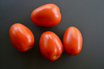 red tomato on black background