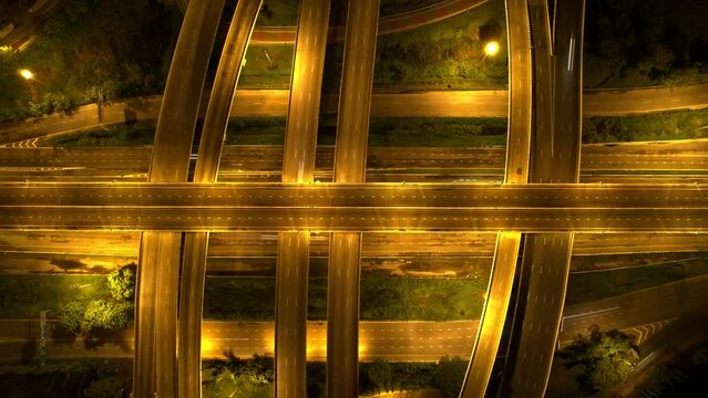4K : Aerial view shot of fast moving above interchange and multi junction road. night traffic time lapse. infrastructure in thailand. hyperlapse. traffic in Bangkok, Thailand
