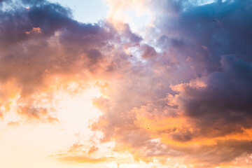 Beautiful evening sky with colorful clouds. Sunset sky with puffy clouds. Textured sky background