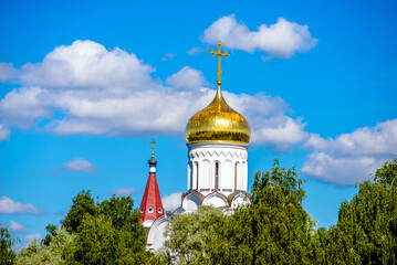 Fototapeta na wymiar Domes of the Orthodox Church with crosses against the blue sky