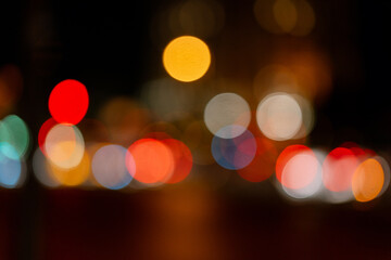 Bokeh traffic light at night in the street of a big city for background