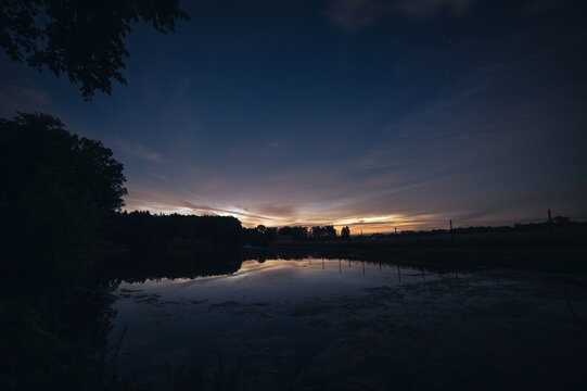 noctilucent clouds above lake in northern Germany. High quality photo