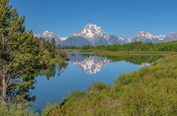 Fototapeta na wymiar Tetons reflecting on a lake and wilderness.