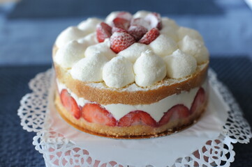 A delicious white and red strawberry and whipped cream cake for birthday and wedding with decoration