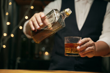 Barman pouring whiskey whiskey glass beautiful night