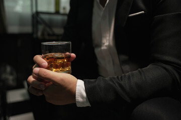 Businessmen in suits drinking whiskey