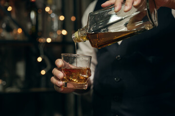 Barman pouring whiskey whiskey glass beautiful night