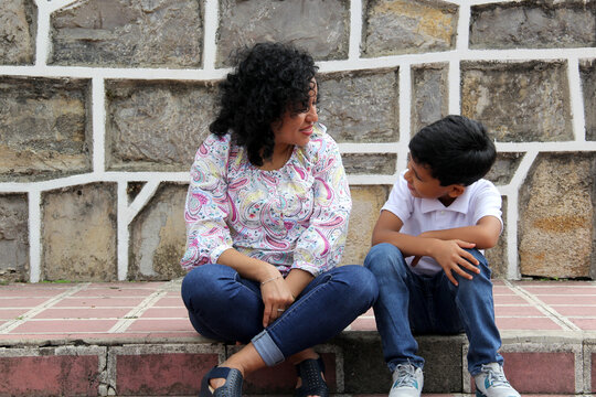 Dark-haired Latin Mom And Son Play And Have Fun Together Spend Quality Time Playing In A Park Without Toys Or A Cell Phone They Live In Poverty And Happiness
