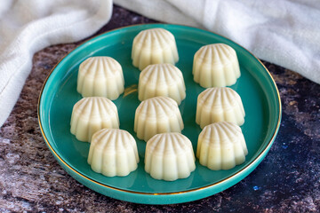 White chocolate. Special mussel-looking chocolate. Special chocolate on colored background. close up