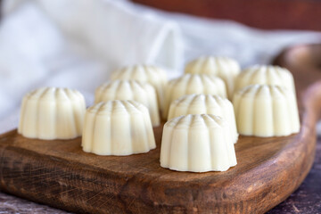 White chocolate. Special mussel-looking chocolate. Special chocolate on colored background. close up