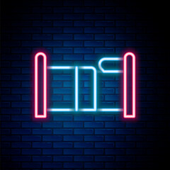 Glowing neon line Bed icon isolated on brick wall background. Colorful outline concept. Vector