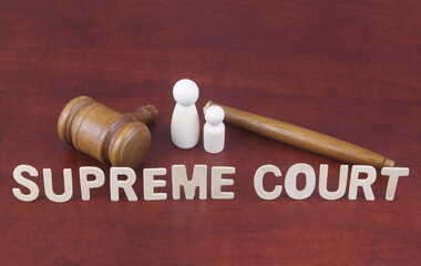 Supreme court wrong decision concept. Words supreme court with broken judge gavel and people...