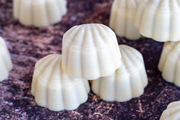 White chocolate. Special mussel-looking chocolate. Special chocolate on colored background. close up