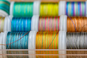 Colored threads for sewing in skeins lie together.