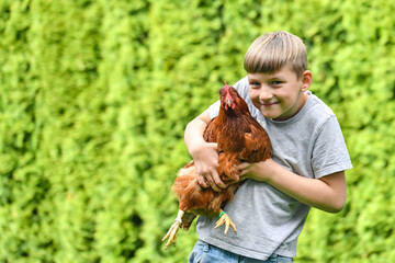 Portrait of a guy with a chicken in his hands.