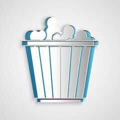 Paper cut Popcorn in cardboard box icon isolated on grey background. Popcorn bucket box. Paper art style. Vector