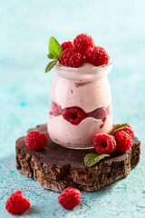 Berry yogurt with fresh raspberries and mint.