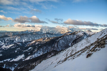 Winter peaks with fresh snow and clouds above it. 