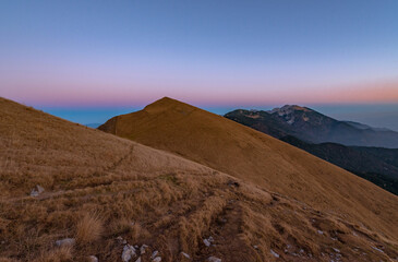 Sunset in the grassy hills in autumn time