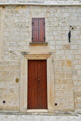 Fototapeta na wymiar The door of an ancient house in the historic center of Tricase, a medieval town in the Puglia region, Italy.