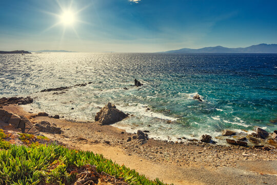 Sunset over Mykonos coast, secluded beach on Cyclades