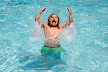 Excited amazed kid splashing in swimming pool. Little child boy in swimming pool swim on summer vacation. Beach sea and water fun.