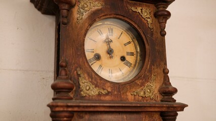 Broken antique mechanical wall clock that once showed the hour in room. Time measurement. Antique...