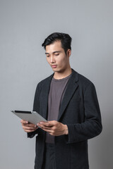 Asian man in semi-formal suit stressed using laptop phone
